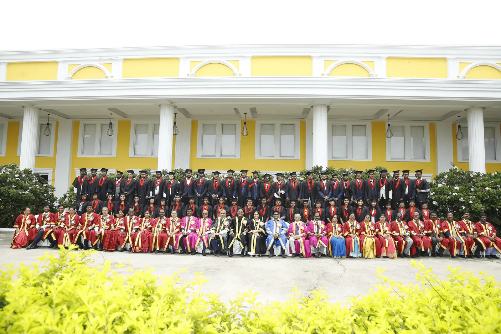 Graduands and faculty assembled outside the AVMCH college building