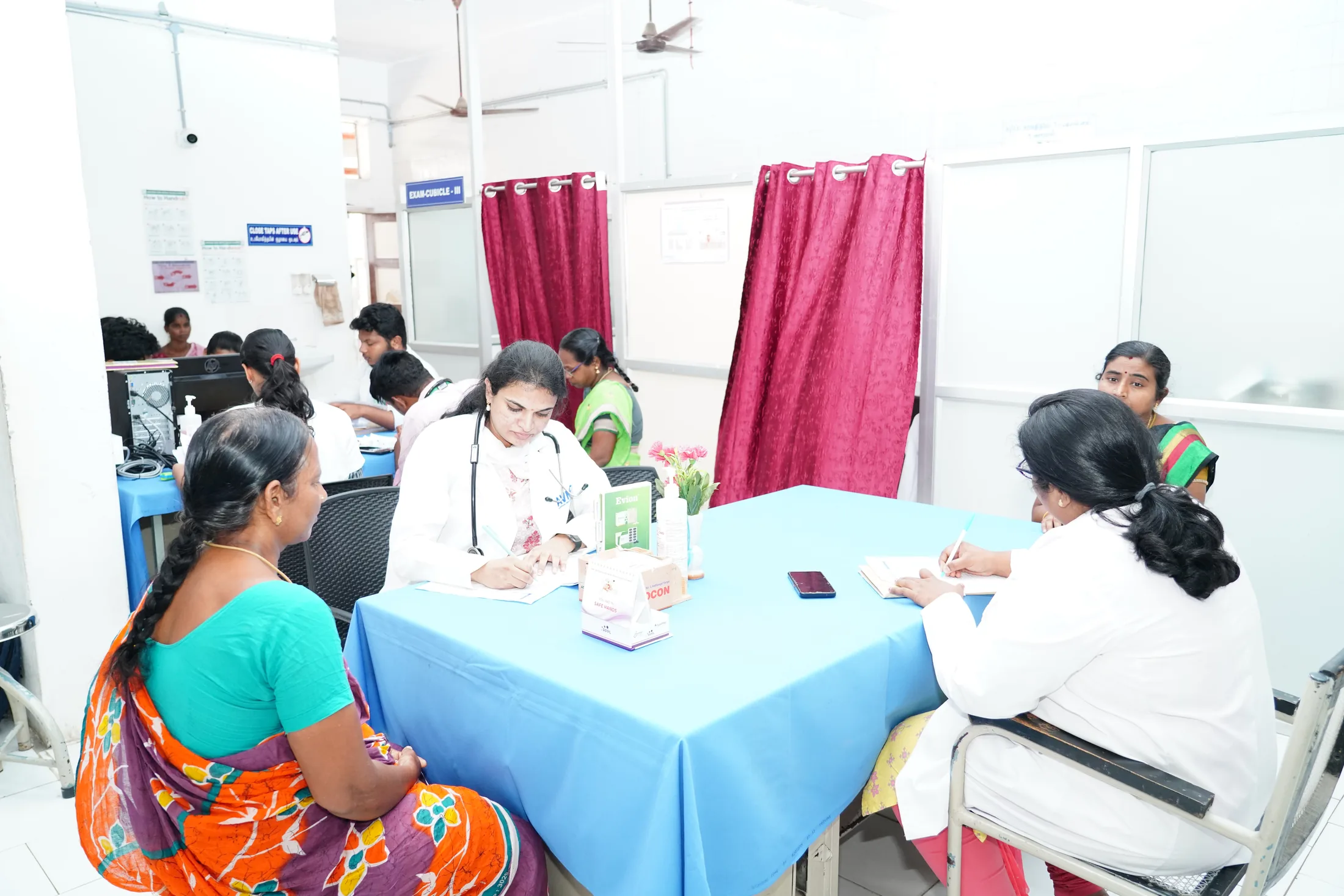 Doctors consulting patients in an AVMCH OPD examination room