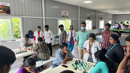 Professors playing a chess game as part of Teacher's Day events